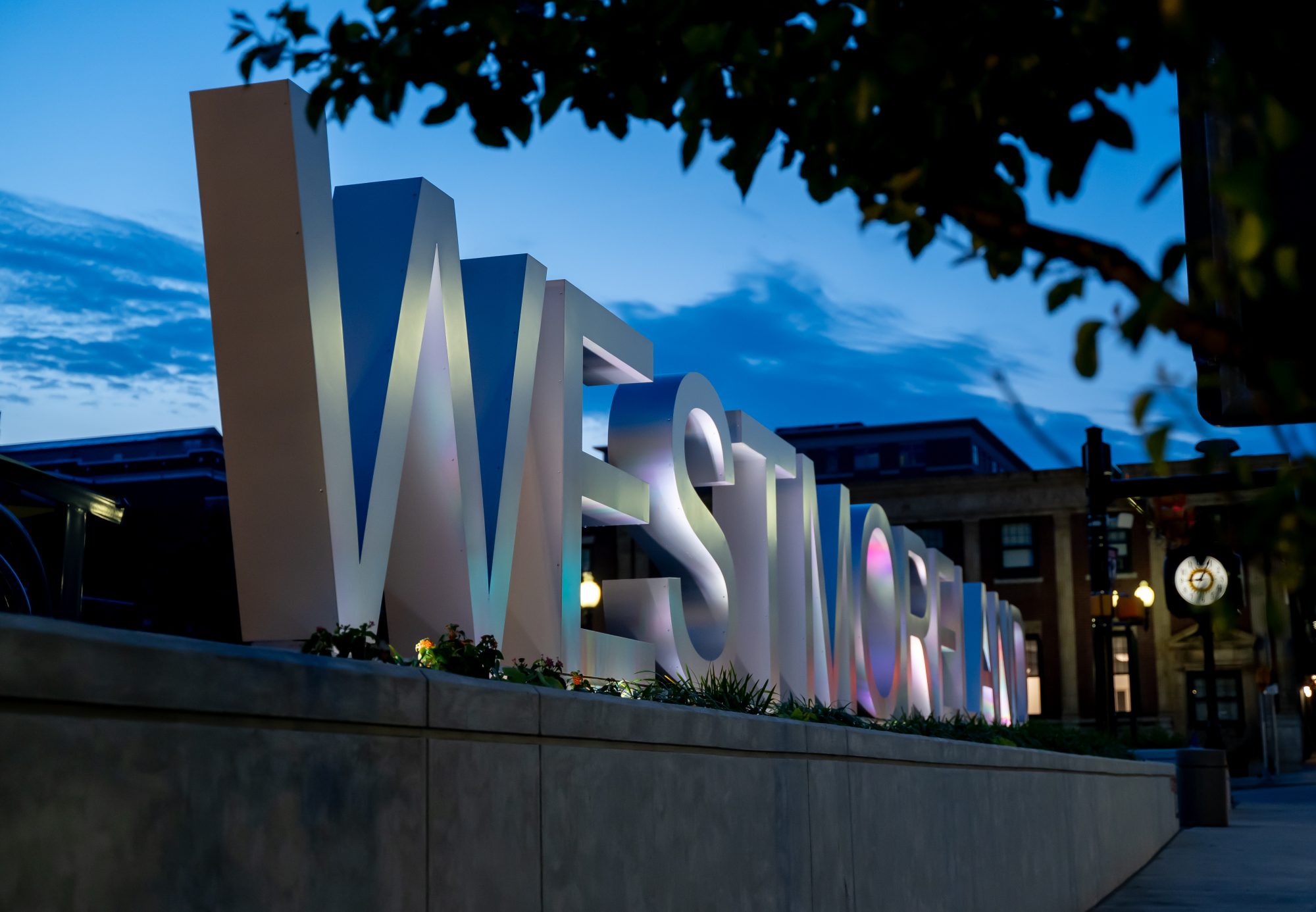 close-up of westmoreland sign at night, showcasing the colored lighting designed by Design 3 Architecture